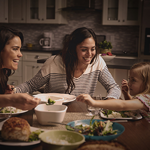 A mother at dinner table with children