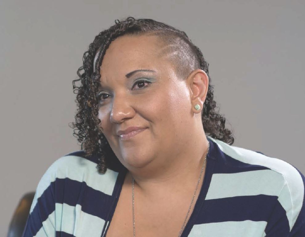 Close up of a young woman wearing a striped shirt.