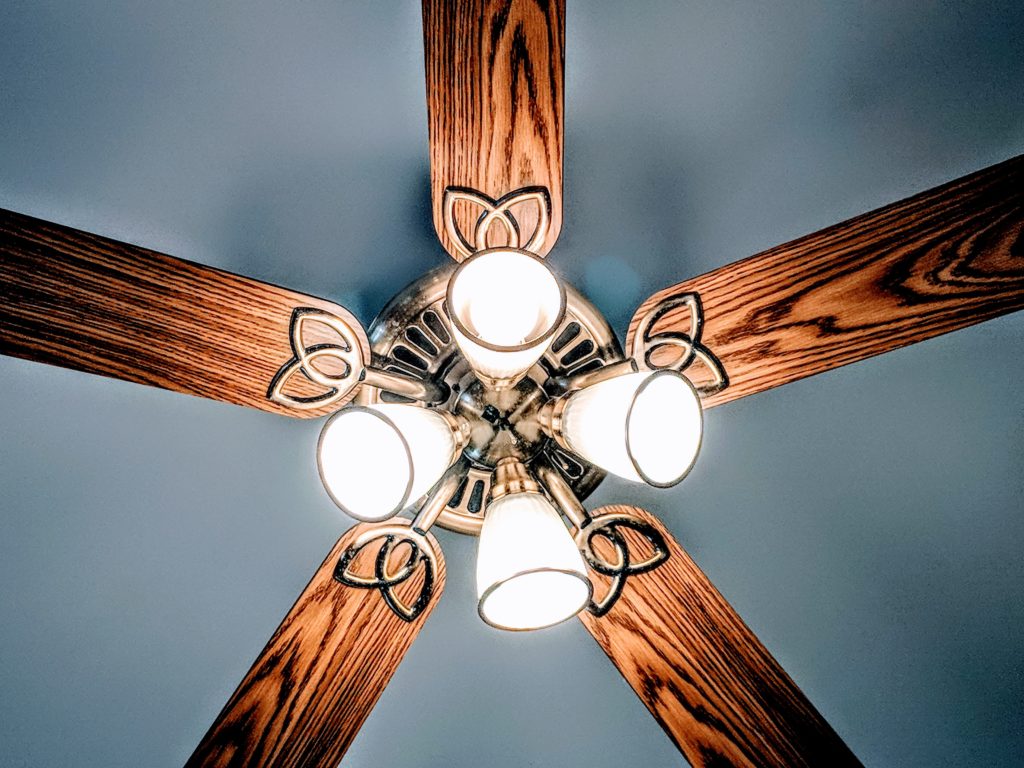 Image of a ceiling fan with four lights.