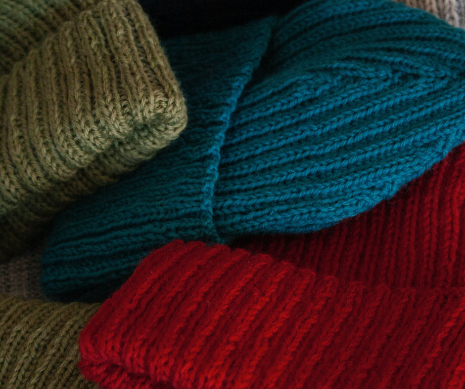 Image of green, red, and blue woven hats.