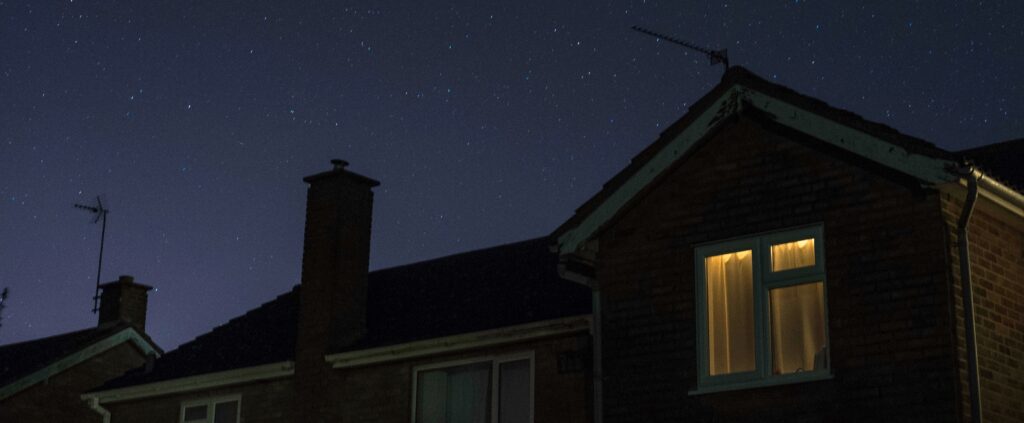 a house at night with a light in the window